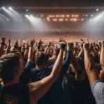 People gathered in a wrestling arena in Germany, surrounded by cheering fans and bright lights